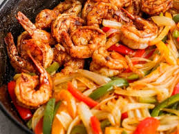 Shrimp with pepper cilantro and limes in a skillet