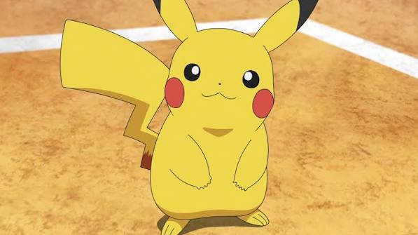 A photo of Ash's Pikachu, from the Pokemon anime series. In this shot, he's smiling while standing in the middle of a battke arena