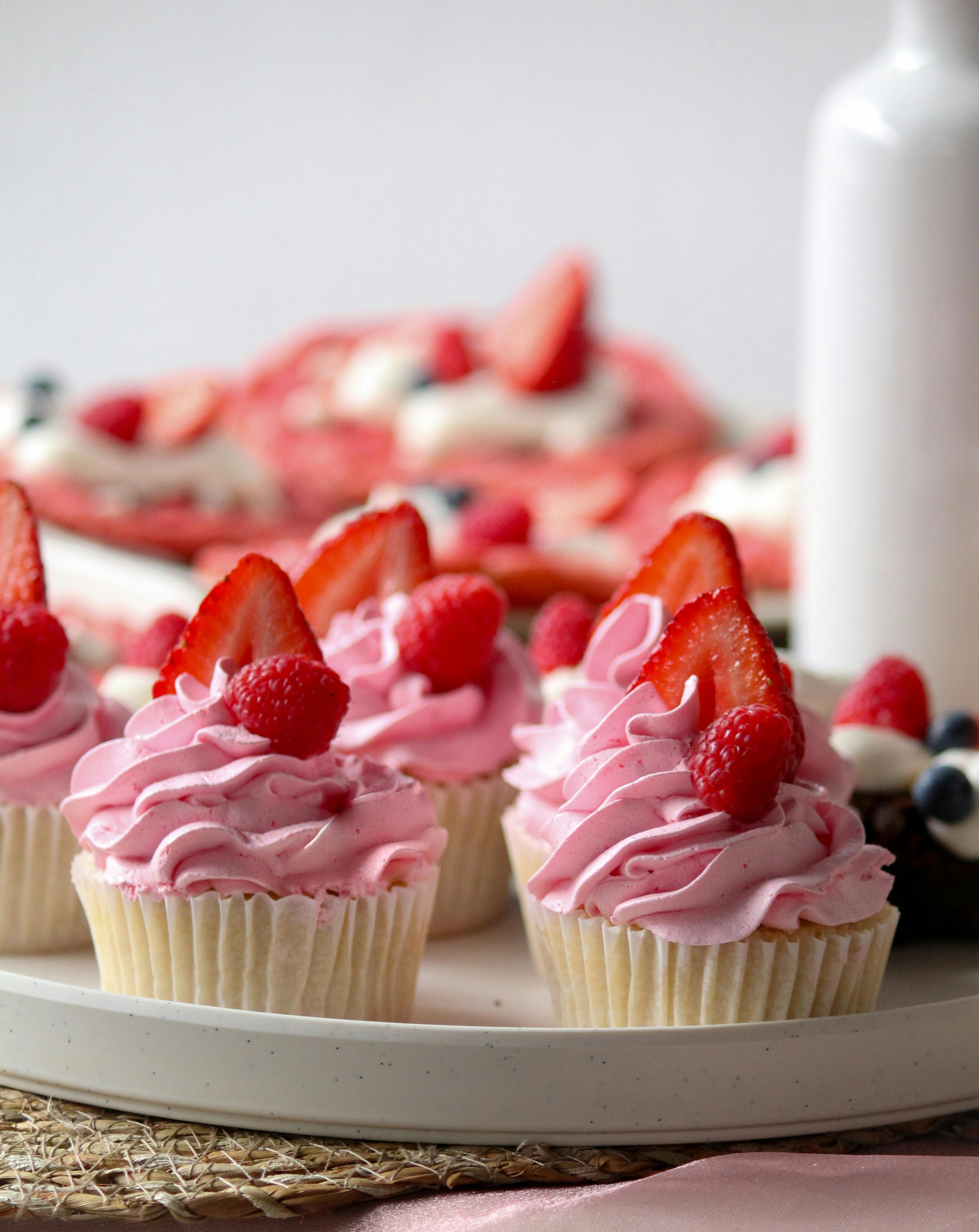 Strawberry Cupcakes with strawberries and raspberries on top