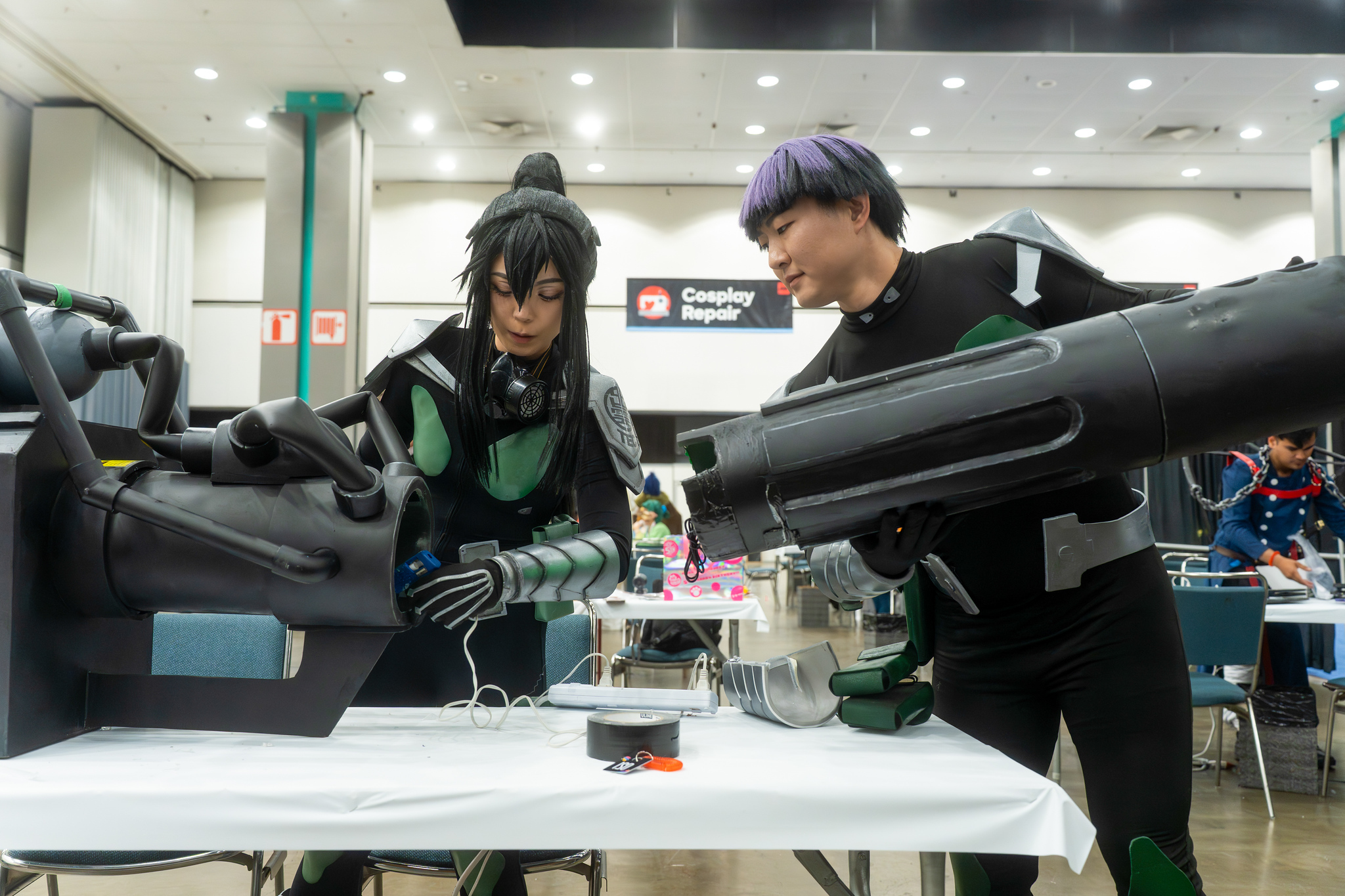 Pair of Cosplayers at a Cosplay Prop repair station
