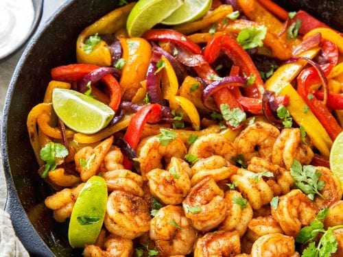 Shrimp with pepper cilantro and limes in a skillet