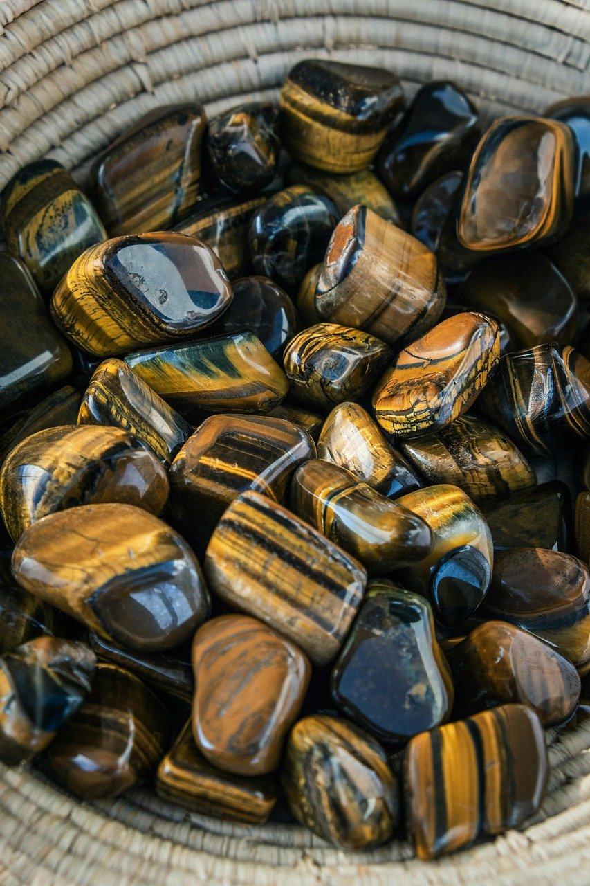 A basket containing a bunch of Tiger's Eye gems.