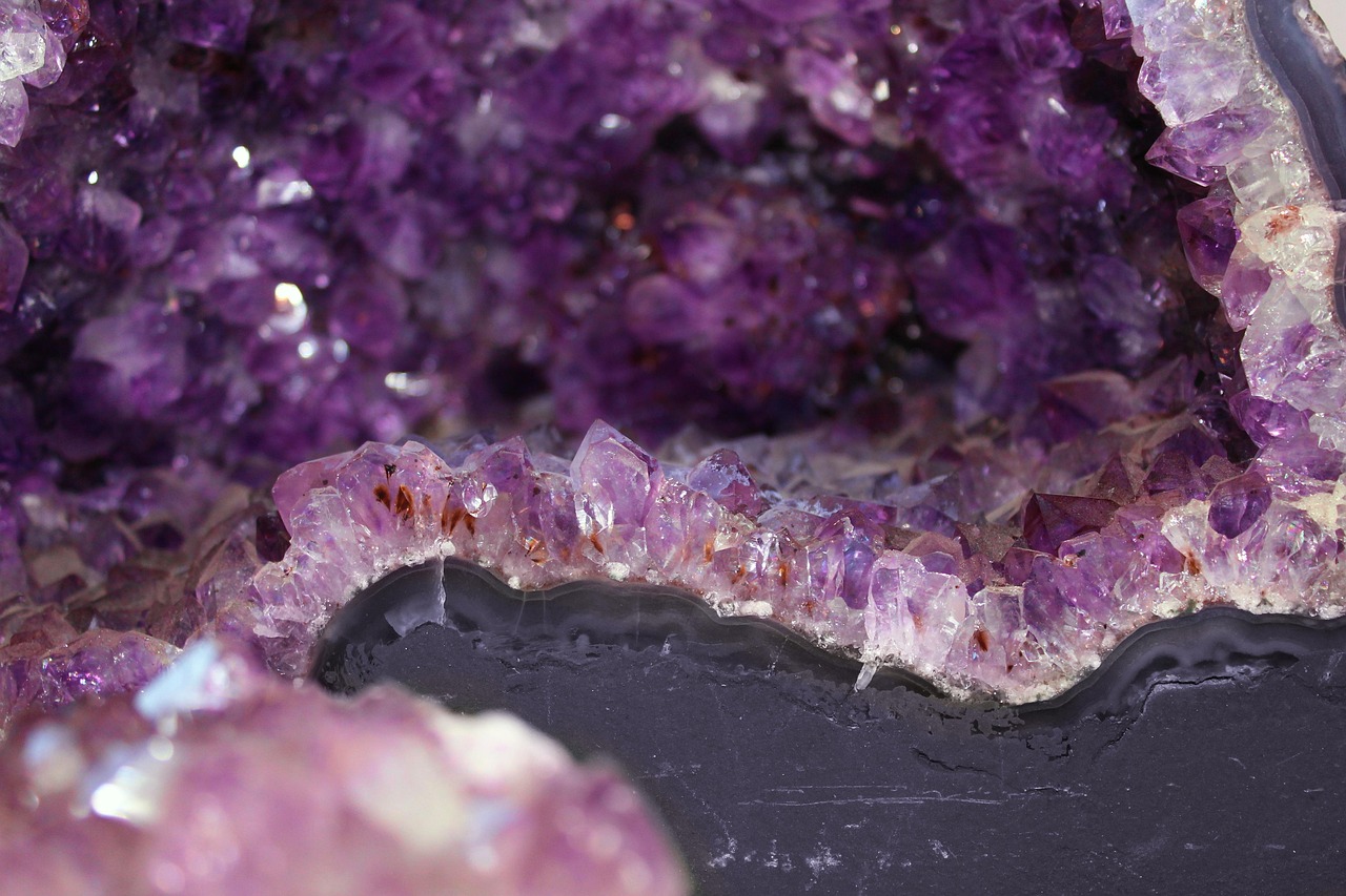 A cracked geode containing amethyst crystals.